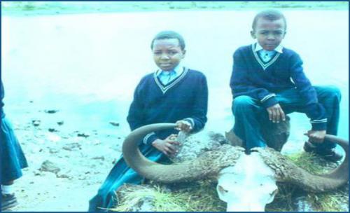 A tour to Arusha National Park, two students behind the bull skull